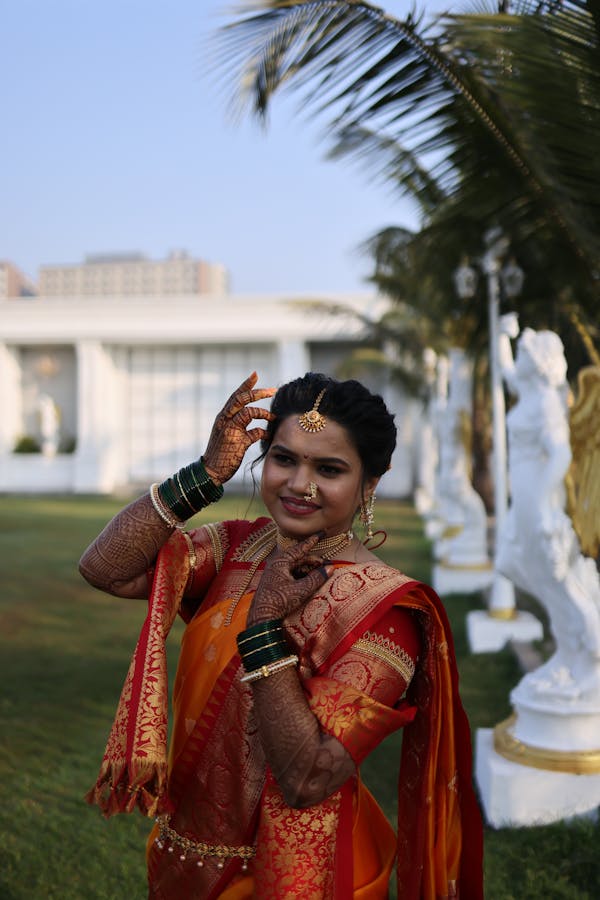 free-photo-of-woman-wearing-orange-sari-in-front-of-a-temple